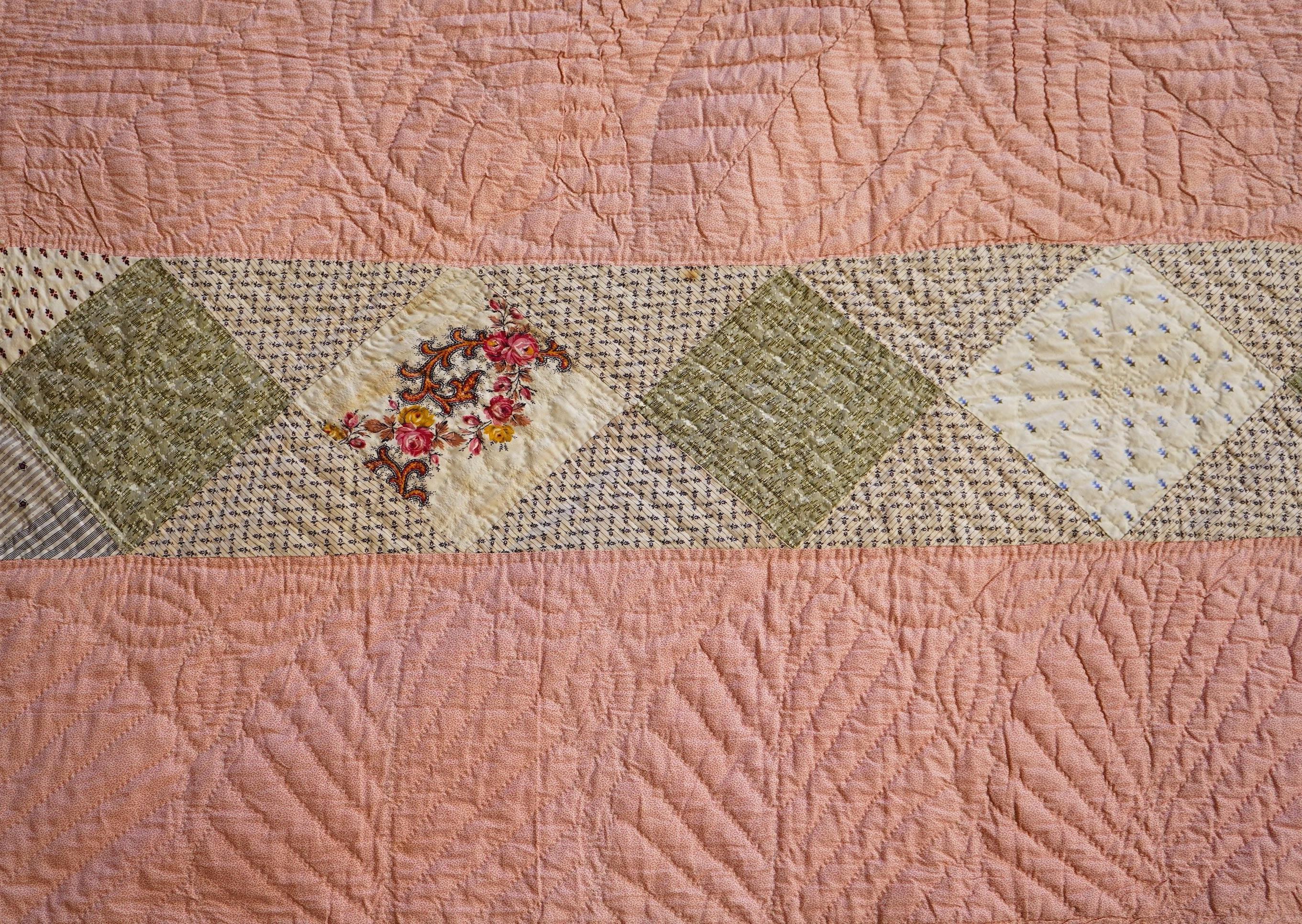 A late 19th century English, possibly ‘North Country’ cotton, hand quilted bed cover. Worked in stripes, with alternate patch worked stripes of differing colour fabrics. Made from fashionable cotton fabrics of the era. R